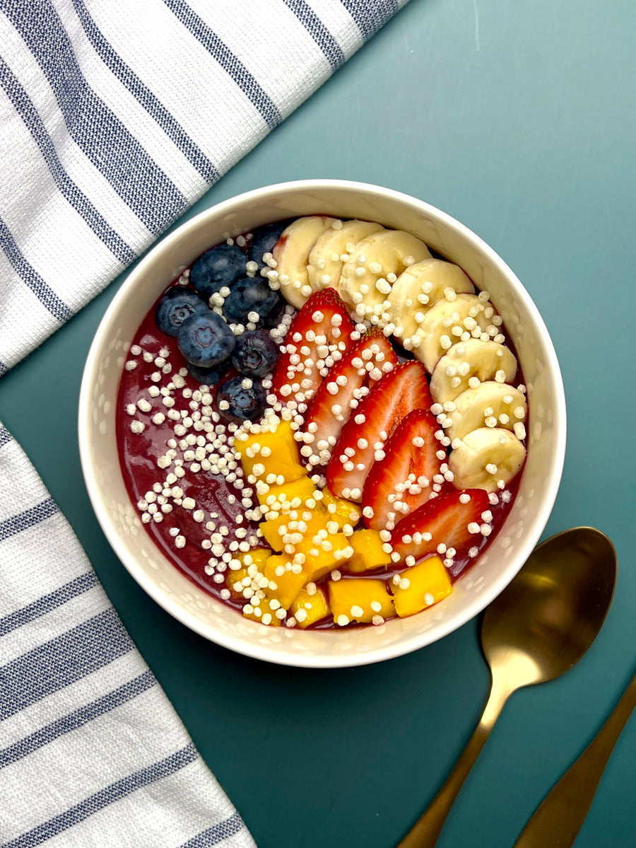 Acai bowl topped with banana, strawberry, blueberry, mango, and LIFTER Crispies